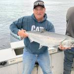 Port Angeles angler Justin Peterson landed this good-sized hatchery chinook while fishing just off shore at the Caves near Sekiu.