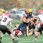 Forks' Nate Dahlgren makes his cut between Wahkiakum defenders in Forks during a playoff game in November 2021. Dahlgren scored a pair of touchdowns in the win. (Lonnie Archibald/for Peninsula Daily News)
