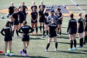 Photo courtesy of Peninsula College 
Coach Kanyon Anderson works with members fo the Peninsula College women's soccer team at a practice earlier this month. The women are defending NWAC champions.