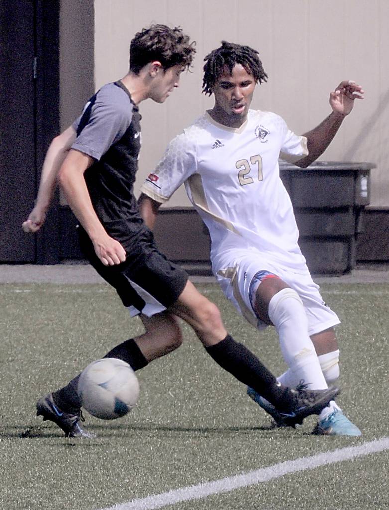 Keith Thorpe/Peninsula Daily News
Peninsula's Abdurahum Leigh, right, fend off Wenatchee Valley's Gaetan Mainaud on Thursday in Port Angeles.