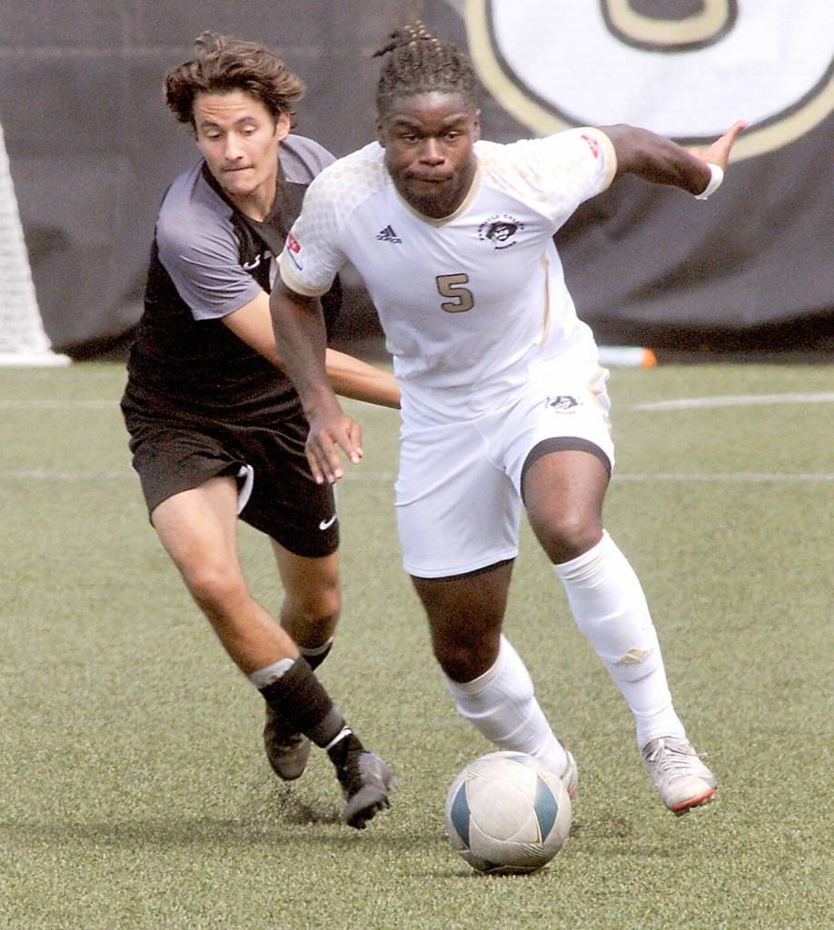 Keith Thorpe/Peninsula Daily News Peninsulas Dylan Pauw, right, tries to outrun Wenatchee Valleys Oscar Chazalet during Thursdays match in Port Angeles.