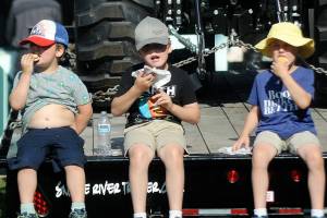 Keith Thorpe/Peninsula Daily News
Siblings, from left, Charlie Jones, 4, Samuel Jones, 8, and August Jones, 6, all of Port Angeles, eat fresh scones on Thursday at the Clallam County Fair.