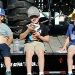 Siblings, from left, Charlie Jones, 4, Samuel Jones, 8, and August Jones, 6, all of Port Angeles, eat fresh scones at the Clallam County Fair. (Keith Thorpe/Peninsula Daily News)