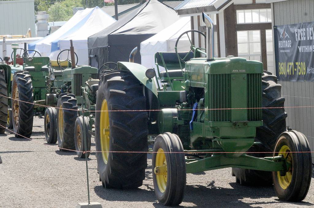A line of vintage tractors stands on display at the Clallam County Fair on Thursday. (Keith Thorpe/Peninsula Daily News)