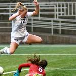Jay Cline/for Peninsula College
Peninsula College's Kyrsten McGuffey hurdles Columbia Basin goalkeeper RiaJo Schwartz during the first half of the Pirates 2-1 come-from-behind win over the Hawks in the NWAC Semifinals on Friday at Starfire Sports Stadium.