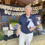 Ron Crawford, one of seven Washington State Fair commissioners, visited the Clallam County Fair on Saturday to evaluate it in a wide range of categories from the quality of its livestock and agricultural exhibits to cleanliness to the education value of displays. (Paula Hunt/Peninsula Daily News)