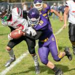 Quilcenes James Miller, right, hauls down Neah Bays Neil Bowechop during an October 2021 contest in Quilcene. (Steve Mullensky/for Peninsula Daily News)