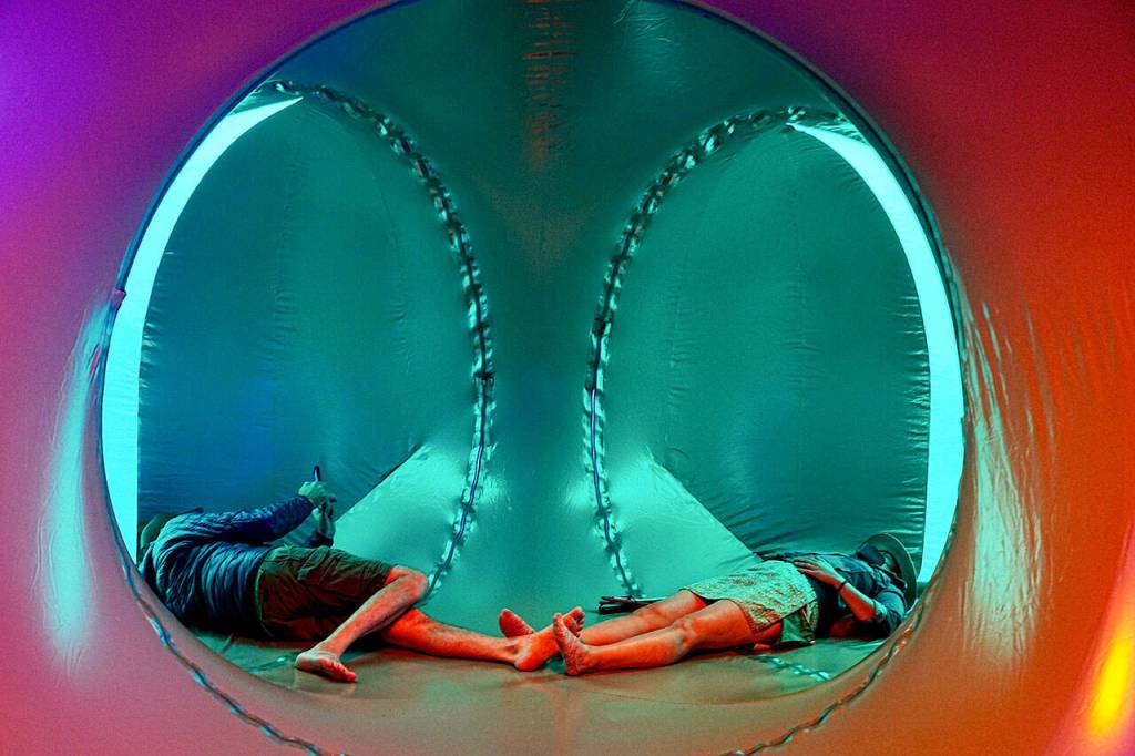 A couple takes time out inside the Lumenarium to take a break and meditate at the THING Arts and Music Festival on Friday at Fort Worden State Park. (Steve Mullensky/for Peninsula Daily News)