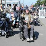 Ian Mackay of Agnew, center, prepares to lead a group of wheelchair, bicyclists, runners and others on a portion of Sea-to-Sound, a three-day, 74-mile multi-modal group ride along a section of the Waterfront Trail in Port Angeles on Saturday. The excursion, which followed numerous portions of the Olympic Discovery from west of Lake Crescent to the Larry Scott Trail in Jefferson County, ended Sunday. It was organized through Ians Ride, a nonprofit organization the advocates outdoor accessibility for all. (Keith Thorpe/Peninsula Daily News)