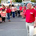 Members of the Port Angeles Education Association and its president John Henry, right, rallied at the Port Angeles School Districts Lincoln Center administrative building Wednesday evening just hours before the union called for a strike to begin Tuesday if an agreement is not reached. (Paula Hunt/Peninsula Daily News)