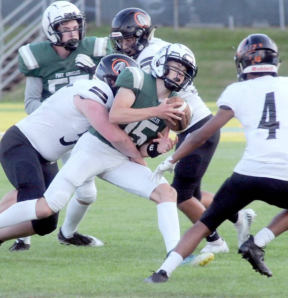 Port Angeles quarterback Parker Nickerson, center is wrapped up by the Blaine defense on Friday night at Port Angeles Civic Field. (Keith Thorpe/Peninsula Daily News)