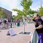 Erik Rohde from Whidbey Island, a member of the Washington Three Percenters with other protesters, trades barbs with counter protesters over a buffer zone created by the Port Townsend police to control possible violence between the two factions during a rally at Pope Marine Park in Port Townsend on Saturday. (Steve Mullensky/for Peninsula Daily News)