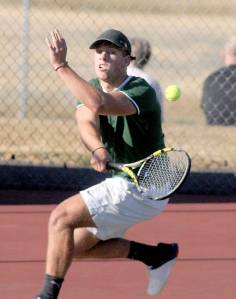 KEITH THORPE/PENINSULA DAILY NEWS
Port Angeles' Reef Gelder hits the return against Bremerton's Jackson Warner in singles play on Wednesday at Port Angeles High School.