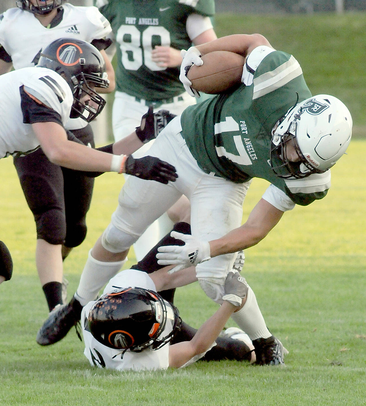 Port Angeles Jason Hawes is brought down by Blains Riley Ihde and Mallory Messenger, left, in second quarter play on Friday evening in Port Angeles. (Keith Thorpe/Peninsula Daily News)