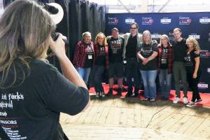 Christi Baron/Olympic Peninsula News Group
Before the Autograph and Photograph Event on Friday, the Forever Twilight in Forks (FTF) committee had a group photo taken with actors Billie Burke and Erik Odom. From left are Teresa Aldrich, Shannon Damron, Rob Hunter, Burke, Lissy Andros, Kelly Grable, Odom and Kim DeMaria. The festival continues today and Sunday. It highlights the town in which author Stephenie Meyer set her four novels released from 2005 through 2008, about a romance between 17-year-old Isabella Swan, a mortal, and 104-year-old vampire Edward Cullen — all of which spawned five movies.