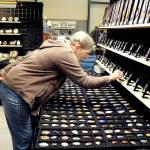 Laurie Nichols of Port Angeles examines a display of gems and pendants at the Rock, Gem & Jewelry Show at Vern Burton Community Center in Port Angeles. The show, hosted by the Clallam County Gem & Mineral Association over the weekend, featured a wide variety of rocks, minerals, crystals and fossils from around the world for sale and for show. (Keith Thorpe/Peninsula Daily News)
