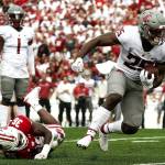 Washington State's Nakia Watson (25) runs past Wisconsin's Jake Chaney (36) during the first half of an NCAA college football game Saturday in Madison, Wis. (AP Photo/Morry Gash)