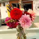 Colorful bouquets of late-summer blooms decorate many of the boats at the 45th Wooden Boat Festival. As they have for about eight years, members of the Port Townsend High School sailing club gather donations of flowers, create bouquets and sell them for $10 to boat owners. The 65 bouquets sold out quickly. (Paula Hunt/Peninsula Daily News)