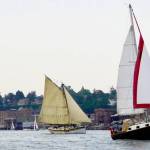 Sailboats cruise by the downtown area of Port Townsend to end the 45th Wooden Boat Festival at Point Hudson Marina on Sunday. (Steve Mullensky/for Peninsula Daily News)