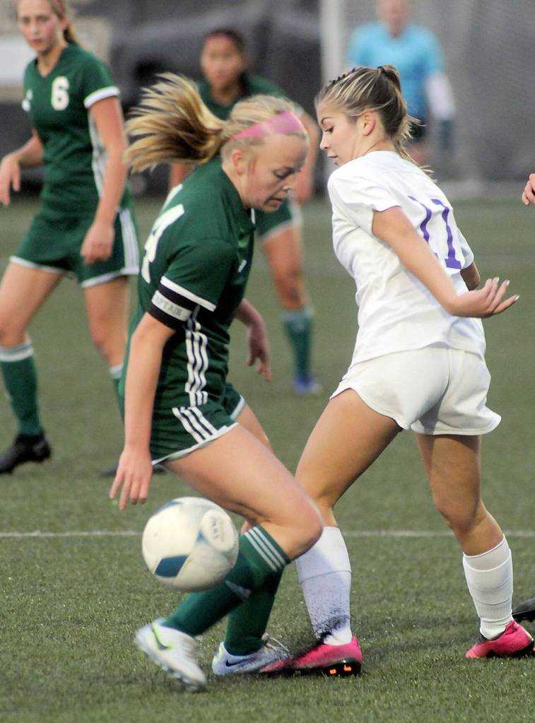KEITH THORPE/PENINSULA DAILY NEWS Port Angeles Anna Petty, left, intercepts a pass from Sequims Alliyah Weber during Thursdays match played at Peninsula College in Port Angeles.