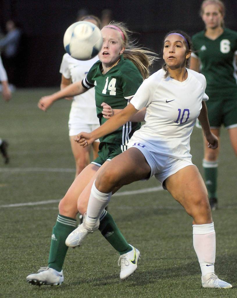 KEITH THORPE/PENINSULA DAILY NEWS Port Angeles Anna Petty, left, fights for a loose ball with Sequims Jennyfer Gomez on Thursday in Port Angeles.