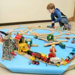 Jackson Chapman, 3, of Sequim plays with a model train display during the 22nd annual Train Show and Swap Meet on Saturday at the Home Arts Building at the Clallam County Fairgrounds in Port Angeles. The two-day event, hosted by the North Olympic Peninsula Railroaders, featured a variety of model railroad sets and accessories for sale or trade, as well as operating train layouts on display. (Keith Thorpe/Peninsula Daily News)
