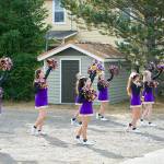 The Quilcene High School cheer squad practices a routine before the start of the Quilcene Fair parade on Saturday. (Steve Mullensky/for Peninsula Daily News)