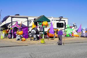 Ray Grier, a 30-year resident of Port Townsend, looks at the Halloween display set up by the park host at the entrance to the RV park at Point Hudson Marina while on his daily 2- to 3-mile walk on Tuesday afternoon. (Steve Mullensky/for Peninsula Daily News)