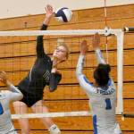 Sequim Gazette photo by Michael Dashiell / Sequim senior Kendall Hastings looks to hit past Olympic's Erika Caryharius, left, and Aviyah Blackwell in a league match-up on Sept. 20.