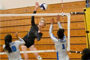 Sequim Gazette photo by Michael Dashiell / Sequim senior Kendall Hastings looks to hit past Olympic's Erika Caryharius, left, and Aviyah Blackwell in a league match-up on Sept. 20.