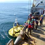 Crew members aboard the U.S. Coast Guard Cutter Henry Blake get ready to pull a weather buoy in the Strait of Juan de Fuca onboard for refurbishment on Tuesday, Sept. 20. The buoy is one of thousands maintained by the National Oceanic and Atmospheric Administration and was in need of repairs after it stopped transmitting data last year. (Peter Segall / Peninsula Daily News)