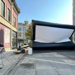 Miles McRae, owner of Full Spectrum Projector and Sound and of the Airscreen, pulls the ropes to control the 15-foot by 30-foot screen as air is pumped into the screen to inflate it for use during the 23rd Port Townsend Film Festival, which started on Thursday. (Steve Mullensky/for Peninsula Daily News)