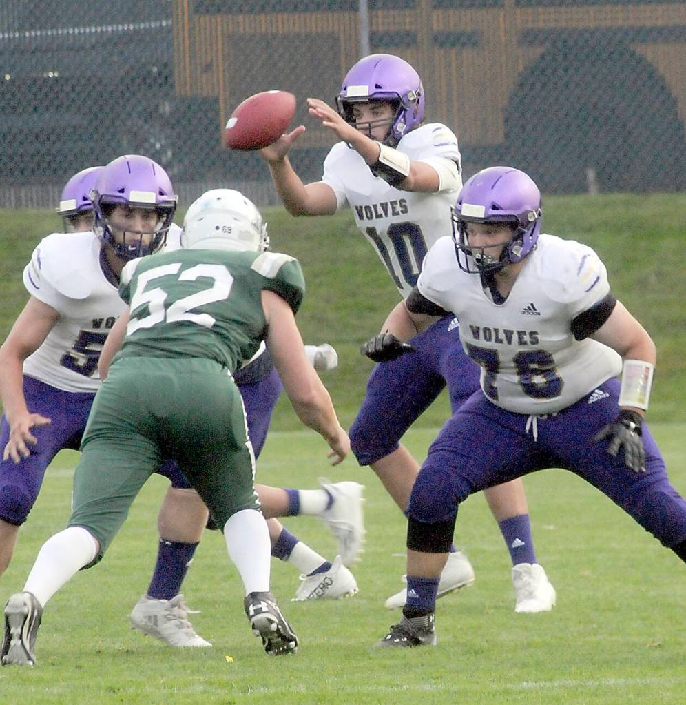 KEITH THORPE/PENINSULA DAILY NEWS
Sequim quarterback Lars Weiker receives the snap as linemen Ayden Holland, left, and XXXX XXXX (No. 78) defend against Port Angeles' Thomas Arand on Friday.