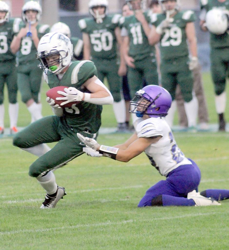 KEITH THORPE/PENINSULA DAILY NEWS Port Angeles Tanner Jacobsen intercepts a pass intended for Sequims Toppy Robideau Jr. during Fridays game in Port Angeles.