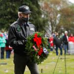 Col. Randy Roberts (U.S. Air Force, ret.) prepares to lay a ceremonial wreath for U.S. military prisoners of war and missing in action at a Wreaths Across American event at Sequim View Cemetery in 2020. (Michael Dashiell/Olympic Peninsula News Group)