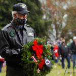 Col. Randy Roberts (U.S. Air Force, ret.) prepares to lay a ceremonial wreath for U.S. military prisoners of war and missing in action at a Wreaths Across American event at Sequim View Cemetery in 2020. Michael Dashiell/Olympic Peninsual News Group