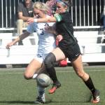 KEITH THORPE/PENINSULA DAILY NEWS Peninsulas Millie Long, left, charges past Shorelines Carlie Cobb on the way to a goal by Long in the first half on Saturday in Port Angeles.