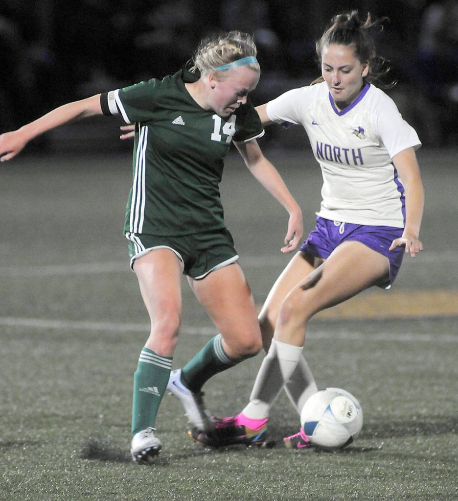Port Angeles Anna Petty, left, fights for control with North Kitsaps Alyssa Peaslee on Tuesday night at Wally Sigmar Field in Port Angeles. (Keith Thorpe/Peninsula Daily News)