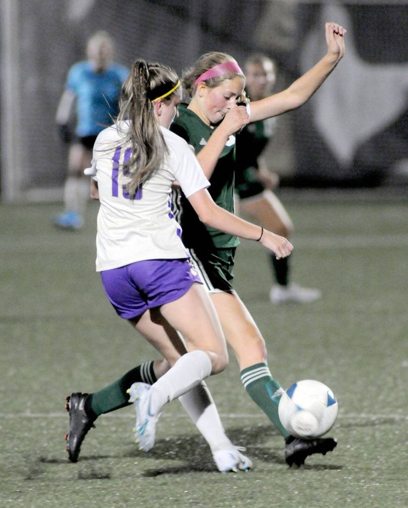 Port Angeles Becca Manson, right, steals the ball from North Kitsaps Jenna Clarke on Tuesday night in Port Angeles. (Keith Thorpe/Peninsula Daily News)