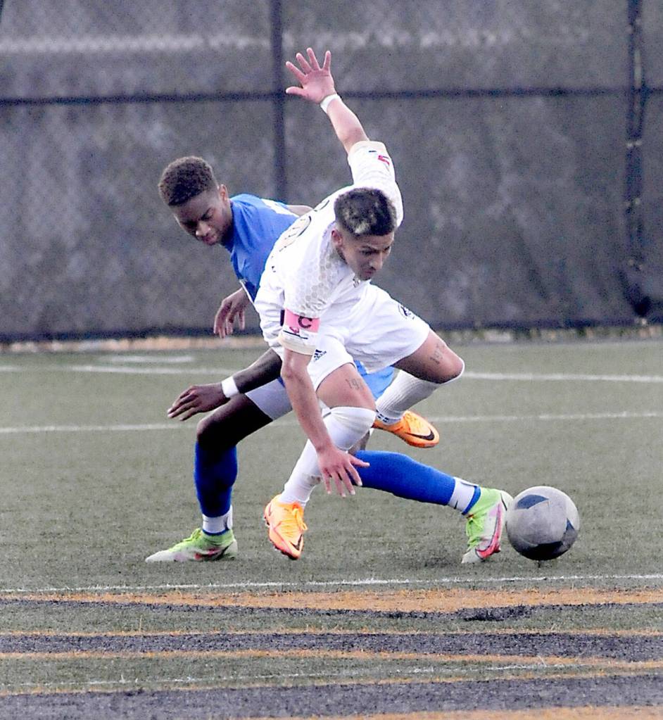 Peninsulas Fernando Tavares, front, scrambles over Edmonds Trevon Hamilton on Wednesday in Port Angeles. (Keith Thorpe/Peninsula Daily News)