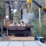 KEITH THORPE/PENINSULA DAILY NEWS
A construction worker welds support pieces for a new pedestrian bridge connecting the historic railroad trestle over the Dungeness River to the Dungeness River Nature Center at Railroad Bridge Park in Sequim on Wednesday. The work is part of a project to restore part of the original Dungeness River floodplain while providing better access to the Olympic Discovery Trail.