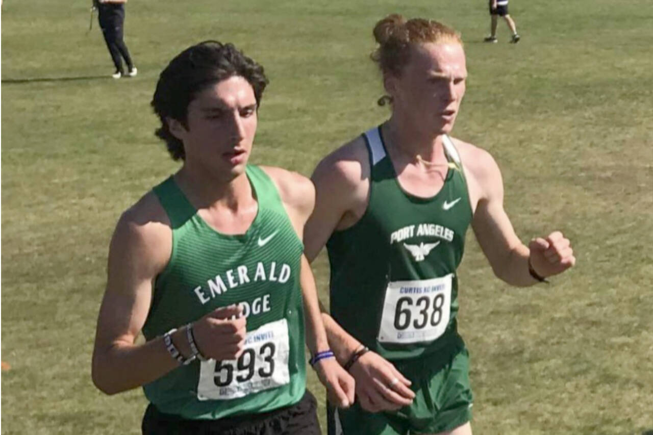 Port Angeles Jack Gladfelter, right, runs alongside Emerald Ridges Conner Wirth at the John Payne/Curtis Cross-Country Invitational this weekend in Tacoma. Gladfelter finished second and a set a Port Angeles High School record. (Courtesy photo)