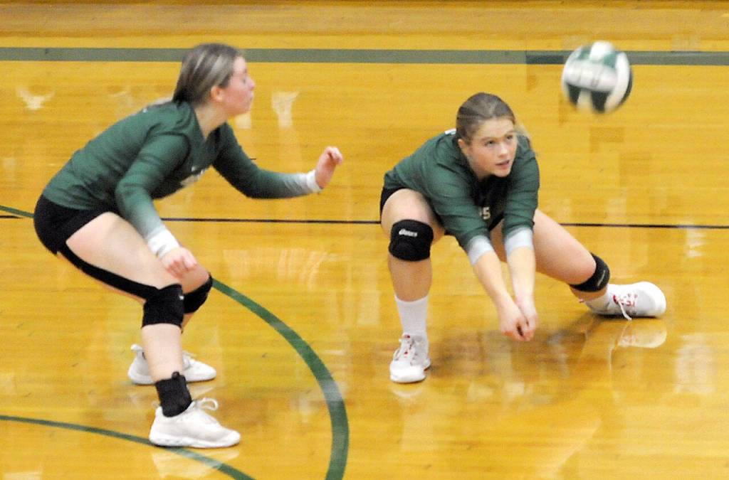KEITH THORPE/PENINSULA DAILY NEWS Port Angeles Lily Halberg, right, goes for the bump as teammate Jayde Wold keeps watch during Tuesdays match against Kingston at Port Angeles High School.