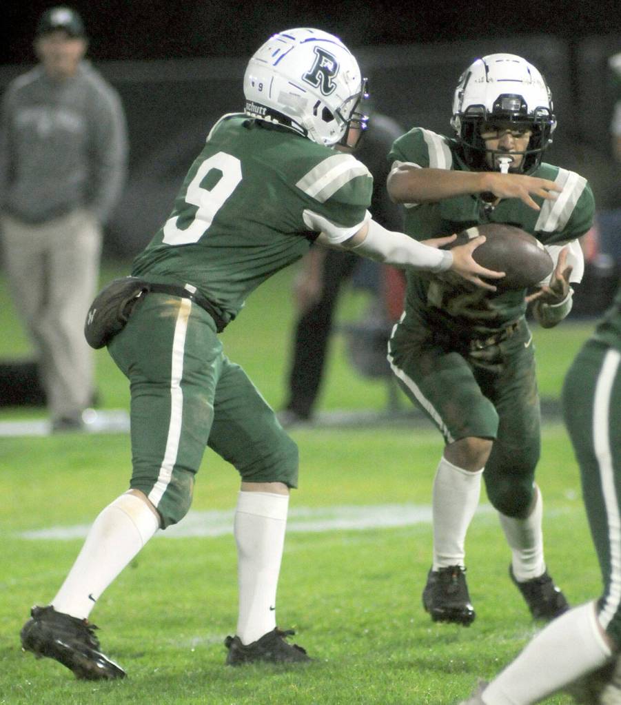 Port Angeles quarterback Brandt Perry, left, makes the handoff to teammate Kason Albaugh during Fridays game against Bremerton in Port Angeles. (KEITH THORPE/PENINSULA DAILY NEWS)