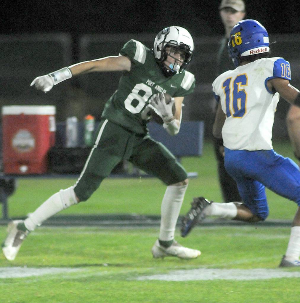 Port Angeles Cole Beeman, left, looks for a way around the defense of Bremertons Dshawn Harvision on Friday at Port Angeles Civic Field. (KEITH THORPE/PENINSULA DAILY NEWS)