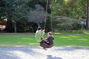 Fiona Krienke, 19, and her brother Hawk, 6, take a spin on the tire swing at Chetzemoka Park in Port Townsend. The 118-year-old city park is named after Chief Chetzemoka, the 19th century SKlallam leader. (Diane Urbani de la Paz/Peninsula Daily News)