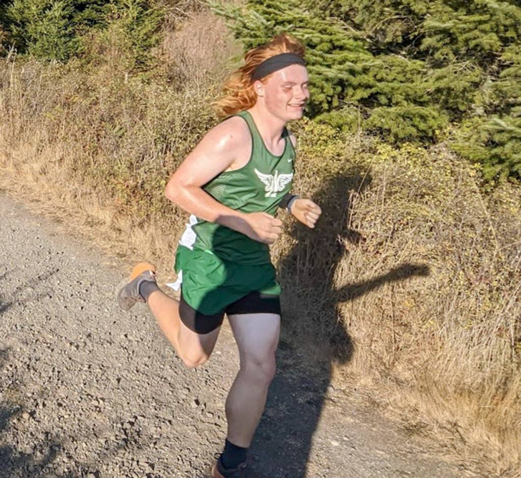 Cooper Berry of Port Angeles runs during an Olympic League Cross Country meet Wednesday at Dungeness Recreation Area near Sequim.