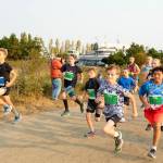Port Townsends Elliot Mull (123) and friend Nick Harper (103), both 10 years old lead, a continent of 10-13 year olds at the start of the 5K Larry Scott Trail Run on Saturday. (Steve Mullensky/Peninsula Daily News)