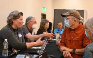 Diana Dupuis, Washington State Parks and Recreation Commission director, talks about development of the Miller Peninsula State Park property with meeting attendees following an open house in Blyn. (Michael Dashiell/Olympic Peninsula News Group)