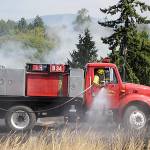 Officials with Clallam County Fire District 3 plan to make a decision in 2023 whether or not to go to voters to approve more funding to add staff, apparatuses and/or new fire stations. Here, firefighters fight a brush fire in July 2021 west of Sequim. (Matthew Nash/Olympic Peninsula News Group)